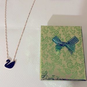 Black and gold swan. Still has tags. Stainless steel. Never worn..